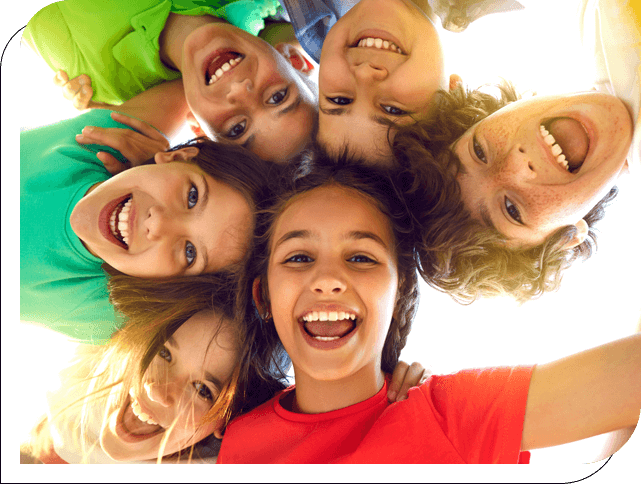 A group of children are smiling for the camera.